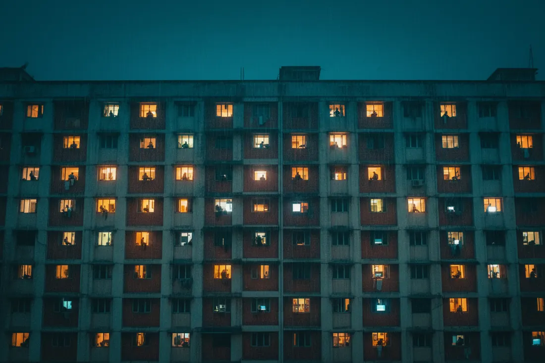 Apartment windows lit up at night